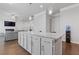 An open-concept kitchen with a central island that overlooks the living room, offering a cohesive and inviting living space at 1784 Treymire Ct, Stone Mountain, GA 30088