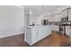 Spacious kitchen boasts a large island with granite countertops, stainless appliances, and gray cabinets for a modern aesthetic at 1784 Treymire Ct, Stone Mountain, GA 30088