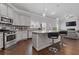 The kitchen features a central island with barstools and overlooks an open-concept living room with a fireplace at 1784 Treymire Ct, Stone Mountain, GA 30088