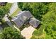Aerial view of a well-maintained home with mature landscaping, driveway, and ample parking at 2802 Nettle Ln, Buford, GA 30519