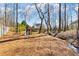 Backyard featuring a play structure, trees, a stream, and a view of the home at 2802 Nettle Ln, Buford, GA 30519