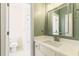 Bathroom with mirror, vanity, and view into tub and toilet room at 2802 Nettle Ln, Buford, GA 30519