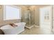 Bathroom features a soaking tub and a glass-enclosed shower, perfect for relaxation at 2802 Nettle Ln, Buford, GA 30519