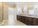Bathroom features double vanities with granite countertops, stylish lighting, and a glass-enclosed shower at 2802 Nettle Ln, Buford, GA 30519