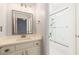 Bathroom with mirror, vanity, and glass-enclosed tiled tub and shower combo at 2802 Nettle Ln, Buford, GA 30519