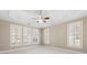 Primary bedroom with natural light showcases trey ceilings and large windows at 2802 Nettle Ln, Buford, GA 30519