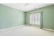 Carpeted bedroom with green walls, white trim and a shuttered window at 2802 Nettle Ln, Buford, GA 30519