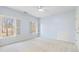 Well-lit bedroom featuring two windows with shutters, light blue walls, and a ceiling fan at 2802 Nettle Ln, Buford, GA 30519