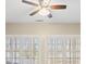 A ceiling fan with lights sits above bright windows with white shutters at 2802 Nettle Ln, Buford, GA 30519