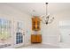 An eating area with outside access, a built in cabinet, and chandelier at 2802 Nettle Ln, Buford, GA 30519