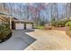 Brick home exterior features a large driveway and two-car garage at 2802 Nettle Ln, Buford, GA 30519