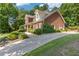 Beautiful brick home featuring a long driveway, manicured landscaping, and mature trees offering privacy at 2802 Nettle Ln, Buford, GA 30519