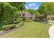 Beautiful two-story brick home with mature trees, landscaping and inviting curb appeal at 2802 Nettle Ln, Buford, GA 30519