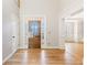 Bright foyer featuring hardwood floors, elegant millwork, and front door with decorative glass at 2802 Nettle Ln, Buford, GA 30519