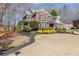 Charming two-story brick home featuring a beautifully landscaped front yard and covered porch at 2802 Nettle Ln, Buford, GA 30519