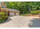 Spacious two-car garage with a wide driveway, brick accents, and plenty of parking space for residents at 2802 Nettle Ln, Buford, GA 30519