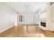 Bright living room with fireplace, built-in shelving, and hardwood floors at 2802 Nettle Ln, Buford, GA 30519