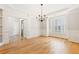 Spacious living room featuring hardwood floors, wainscotting, and natural light at 2802 Nettle Ln, Buford, GA 30519