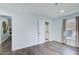 Bedroom featuring wood floors, a pair of windows with curtains, recessed lighting, and easy access to the bathroom at 3433 Keswick Dr, Chamblee, GA 30341