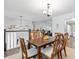 Open dining area with wood table and chairs and view into the living room at 88 Summer Lake Pl, Dallas, GA 30157