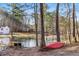 Picturesque lake view with a canoe resting near the shore, creating a tranquil setting for outdoor activities and relaxation at 88 Summer Lake Pl, Dallas, GA 30157