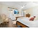 Bright main bedroom featuring wood floors, ceiling fan, and en suite bath access at 88 Summer Lake Pl, Dallas, GA 30157