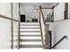 Staircase featuring white risers, dark wood treads, banister, and access to the lower level at 88 Summer Lake Pl, Dallas, GA 30157