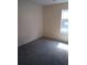 Bedroom featuring gray carpet and window offering plenty of natural light at 1085 Mainstreet Valley Dr, Stone Mountain, GA 30088
