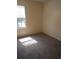 Bedroom featuring gray carpet and window offering plenty of natural light at 1085 Mainstreet Valley Dr, Stone Mountain, GA 30088