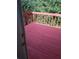 Deck painted red overlooks treed yard at 1085 Mainstreet Valley Dr, Stone Mountain, GA 30088