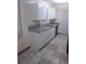 Spacious kitchen featuring white cabinets, granite counters, tile floor, and stainless steel appliances at 1085 Mainstreet Valley Dr, Stone Mountain, GA 30088