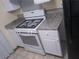 Close up shot of the gas stove and countertops in the kitchen with white cabinets at 1085 Mainstreet Valley Dr, Stone Mountain, GA 30088