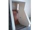 View of the carpeted stairs with white walls and view into the next room at 1085 Mainstreet Valley Dr, Stone Mountain, GA 30088