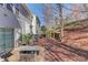 A patio with seating overlooks the backyard with trees at 2033 Fosco Dr, Duluth, GA 30097