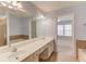 Bathroom with double sinks, soaking tub, shower, and access to main bedroom at 2033 Fosco Dr, Duluth, GA 30097