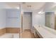 Bright bathroom featuring double sinks, a soaking tub with tile surround, and separate glass enclosed shower at 2033 Fosco Dr, Duluth, GA 30097