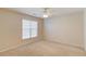 Cozy bedroom with neutral carpet, ceiling fan, and bright window at 2033 Fosco Dr, Duluth, GA 30097