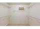 Spacious walk-in closet featuring built-in shelving and carpeted floor at 2033 Fosco Dr, Duluth, GA 30097