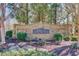 Stone entrance sign with landscaping and mature trees at 2033 Fosco Dr, Duluth, GA 30097