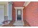 Close-up of the front door with brick surround and elegant trim details at 2033 Fosco Dr, Duluth, GA 30097