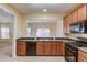 Kitchen features stainless steel appliances, wood cabinets, and an open view to the living space at 2033 Fosco Dr, Duluth, GA 30097