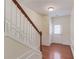 Foyer staircase with hardwood floors, and white wainscoting at 2033 Fosco Dr, Duluth, GA 30097