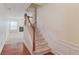 Inviting staircase featuring hardwood floors and classic white trim at 2033 Fosco Dr, Duluth, GA 30097