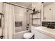 Cozy bathroom with a shower/tub combination, decorative shelving, and modern fixtures at 3045 Riviera Nw Dr, Conyers, GA 30012
