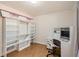 Contemporary room features a built-in desk and shelving unit, sleek white cabinetry, and hardwood floors at 3045 Riviera Nw Dr, Conyers, GA 30012