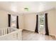 Bright bedroom featuring hardwood floors, neutral walls, and natural light from two windows at 3045 Riviera Nw Dr, Conyers, GA 30012