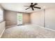 Bedroom with carpet, a back door and a ceiling fan at 3045 Riviera Nw Dr, Conyers, GA 30012