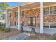 Inviting entrance with brick facade, pillars, and beautiful glass double doors at 3045 Riviera Nw Dr, Conyers, GA 30012