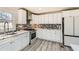 Beautiful kitchen includes white cabinets, stylish countertops, mosaic backsplash, and stainless appliances at 3045 Riviera Nw Dr, Conyers, GA 30012