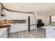 Beautiful kitchen includes white cabinets, stylish countertops, mosaic backsplash, and stainless appliances at 3045 Riviera Nw Dr, Conyers, GA 30012